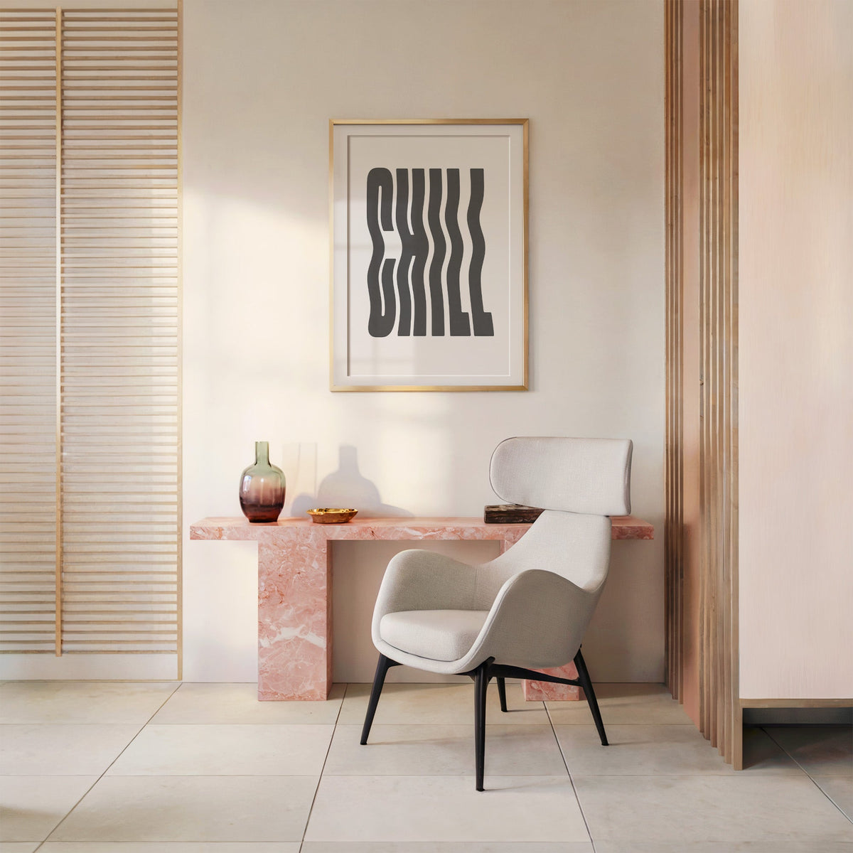 Wavy CHILL lettering on white print shown in a gold frame above a pink marble console and armchair
