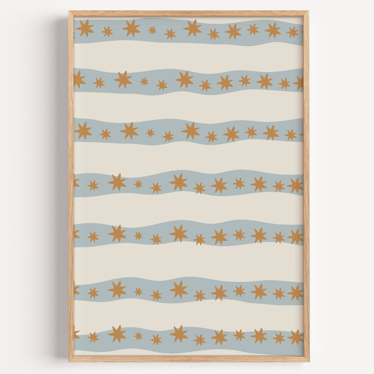 Wavy stripe stars pattern nursery print in a light oak frame on a plain white wall