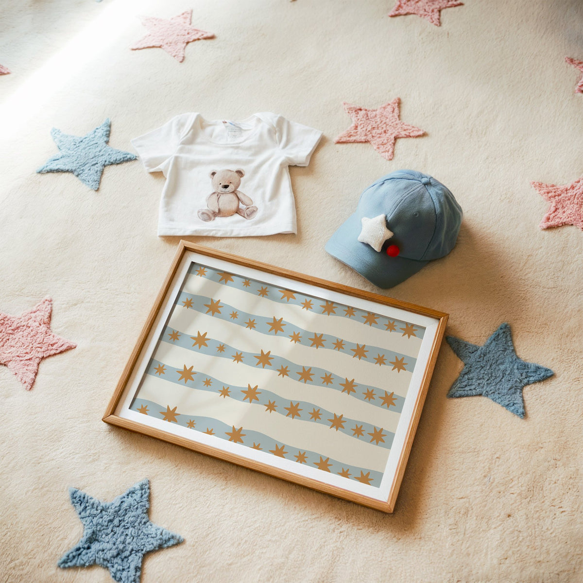 Landscape wavy stripe stars pattern nursery print in a matted oak frame on a star rug with a baby tee
