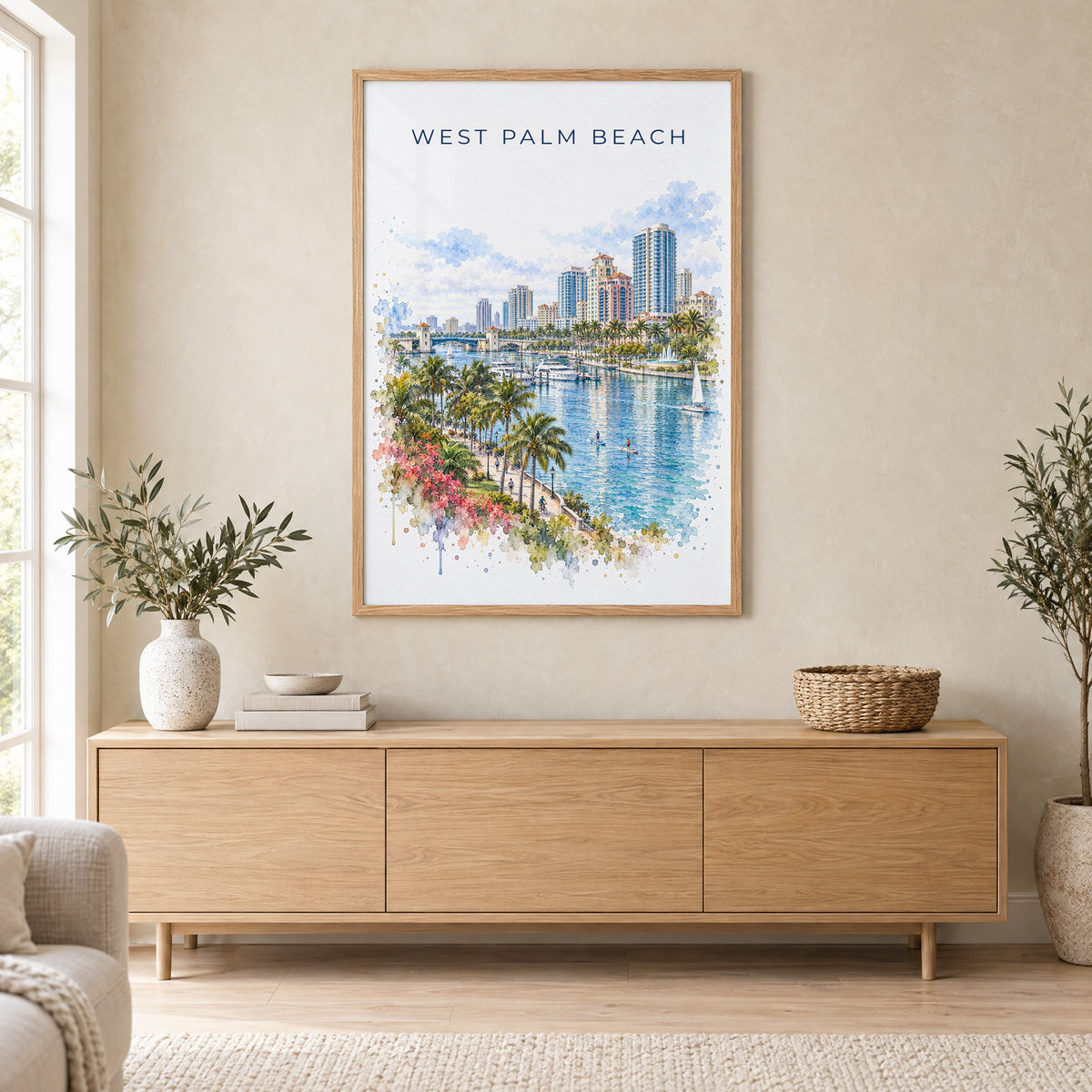 West Palm Beach watercolor print in an oak frame above a light wood sideboard in a Scandinavian living room