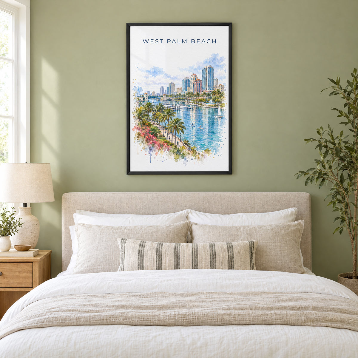West Palm Beach watercolor print in a black frame above an upholstered headboard in a sage green bedroom