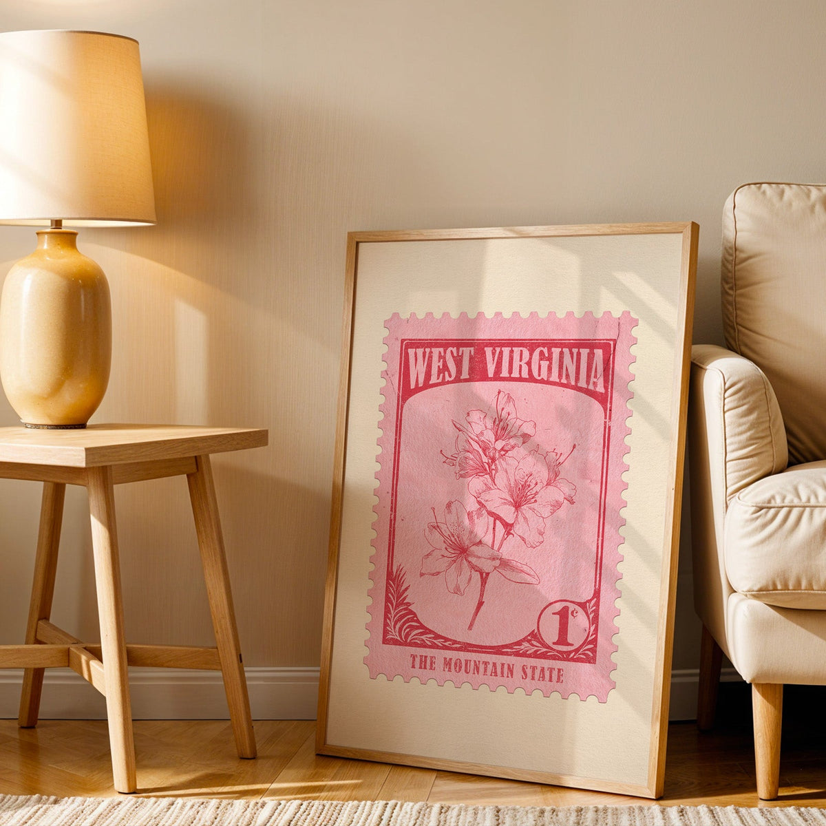 West Virginia stamp print in a wood frame resting on the floor by a beige armchair and yellow lamp