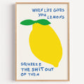 When life gives you lemons print in a light oak frame on a plain white wall
