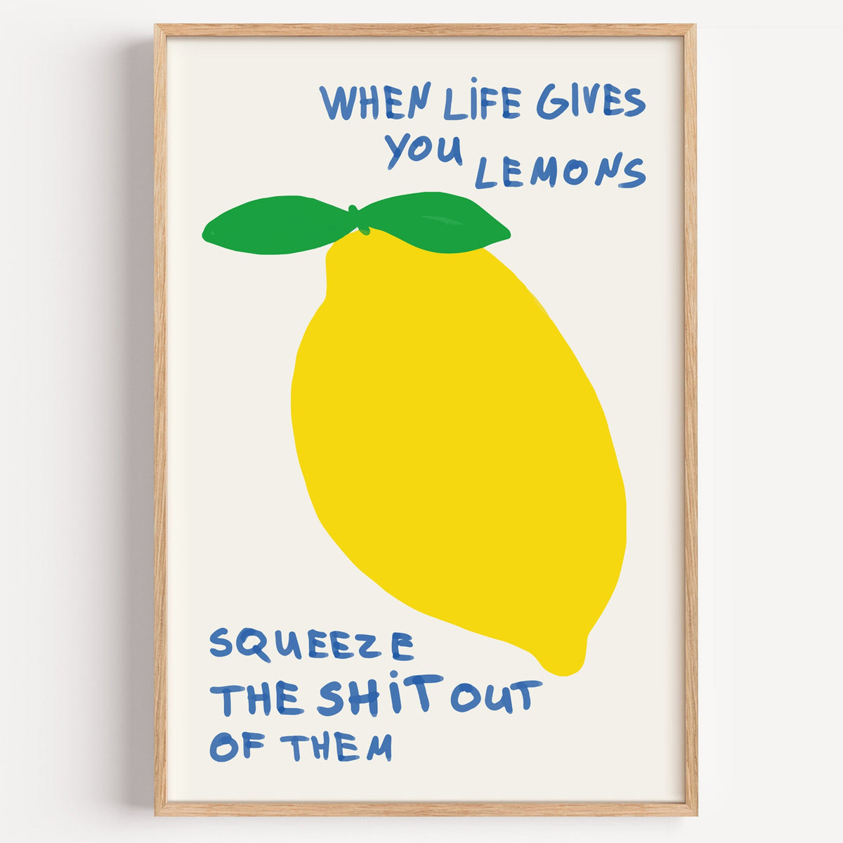 When life gives you lemons print in a light oak frame on a plain white wall