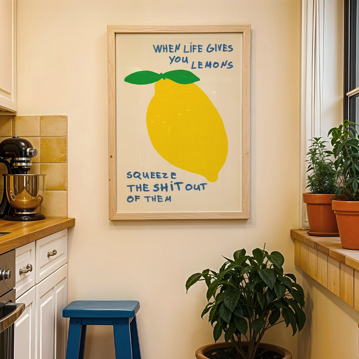 When life gives you lemons print in a wood frame on a yellow tiled kitchen wall