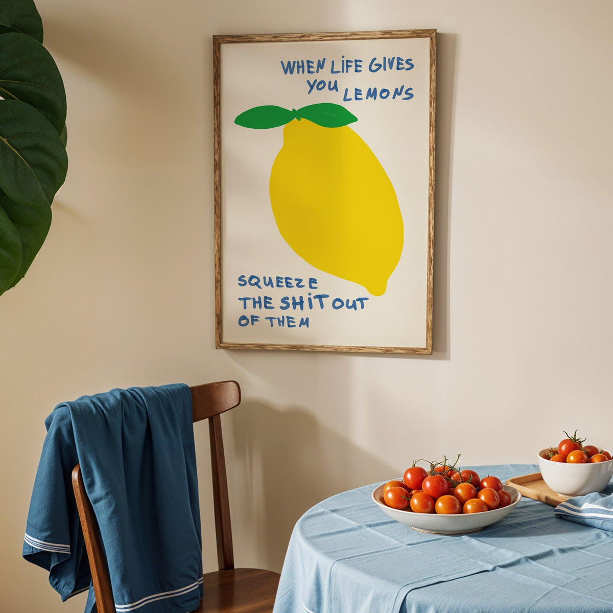 When life gives you lemons print in an oak frame above a blue linen table
