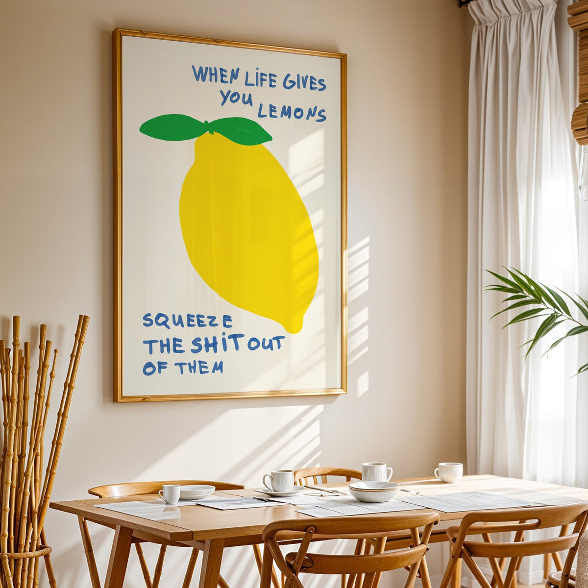 When life gives you lemons print in a gold frame above a sunlit breakfast table