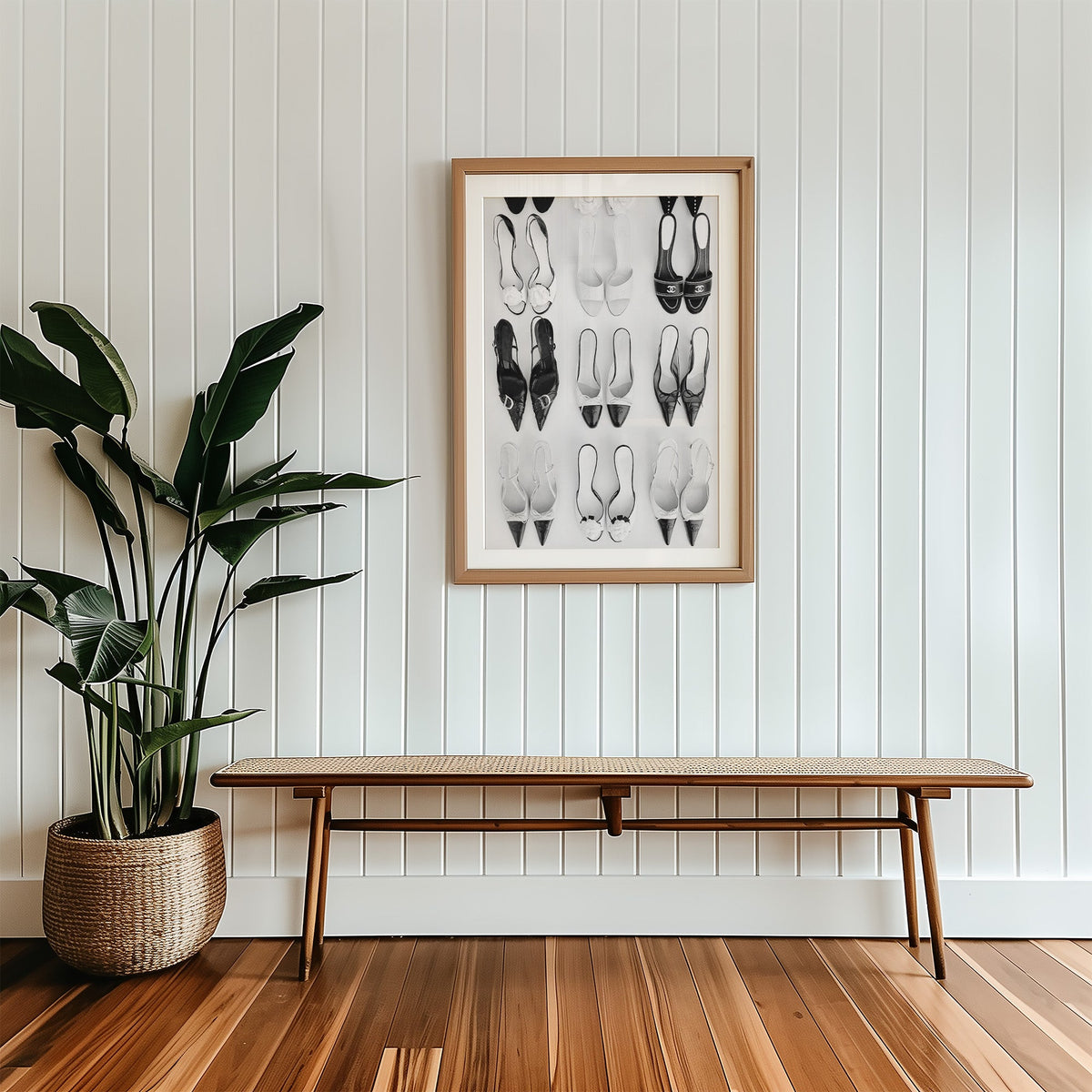 Nine pairs of mules and slingbacks in a grid print in a wood frame with a white mat above a cane bench