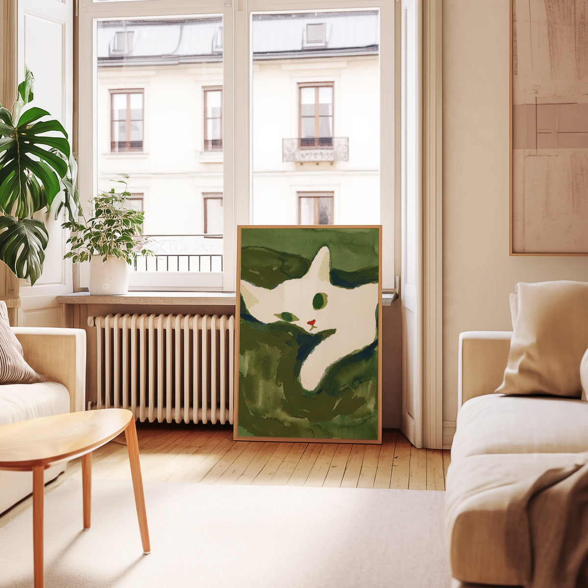 Curled white cat print in an oak frame leaning below tall French windows