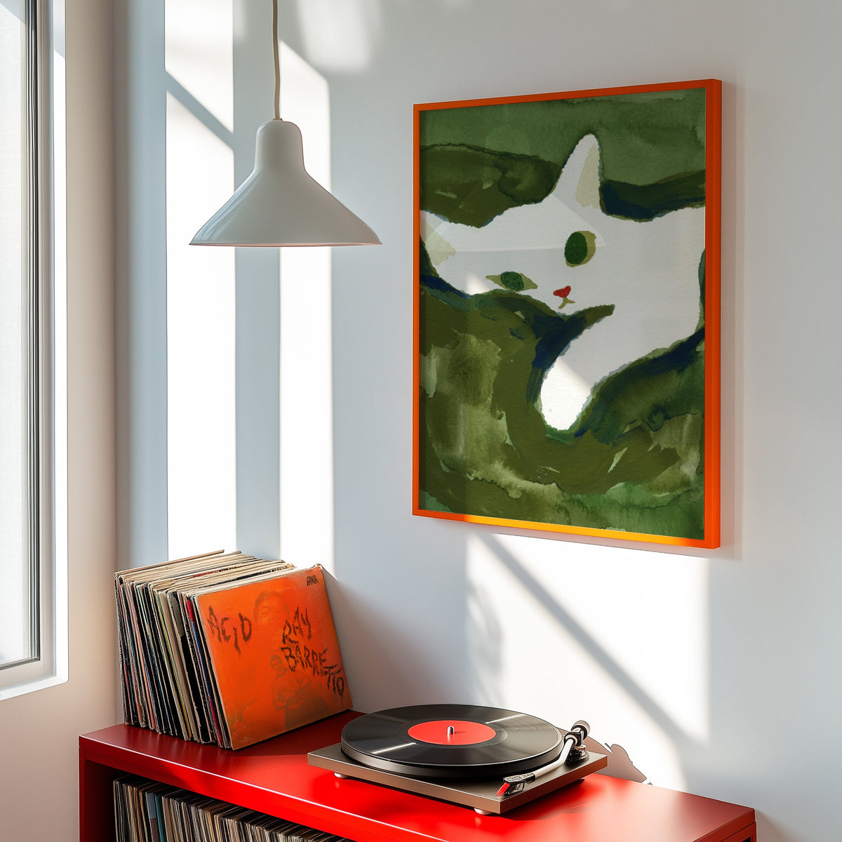 Curled white cat print shown in an orange frame above a red record cabinet and turntable