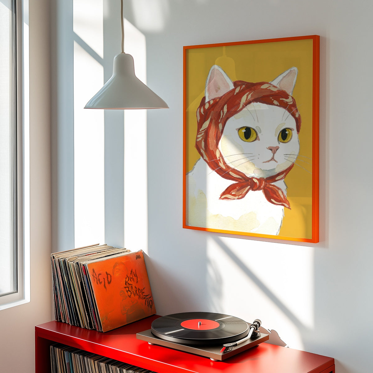 Cat in babushka scarf print shown in an orange frame above a red record cabinet and turntable
