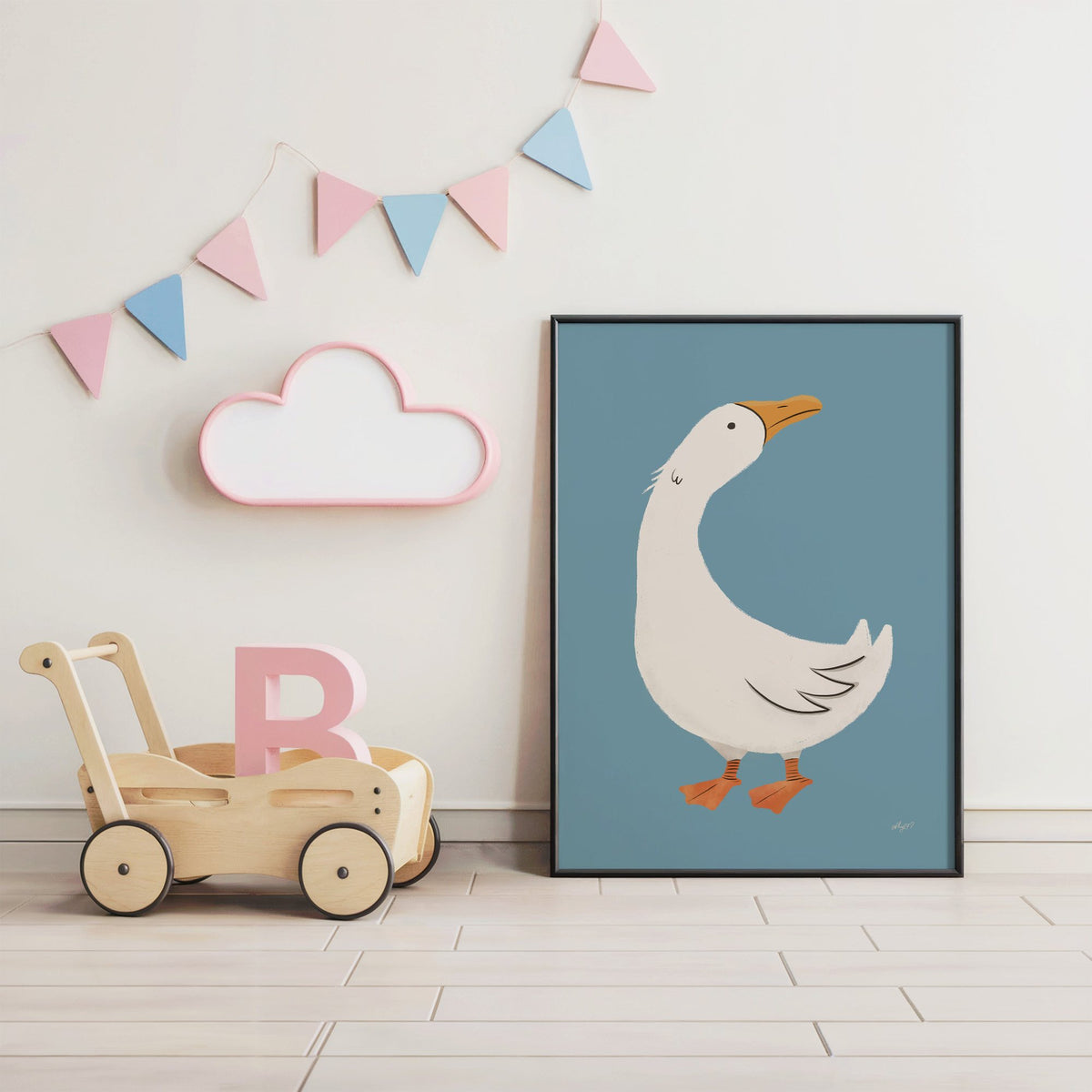 White goose on dusty blue nursery print in a black frame under pastel bunting by a wooden baby walker