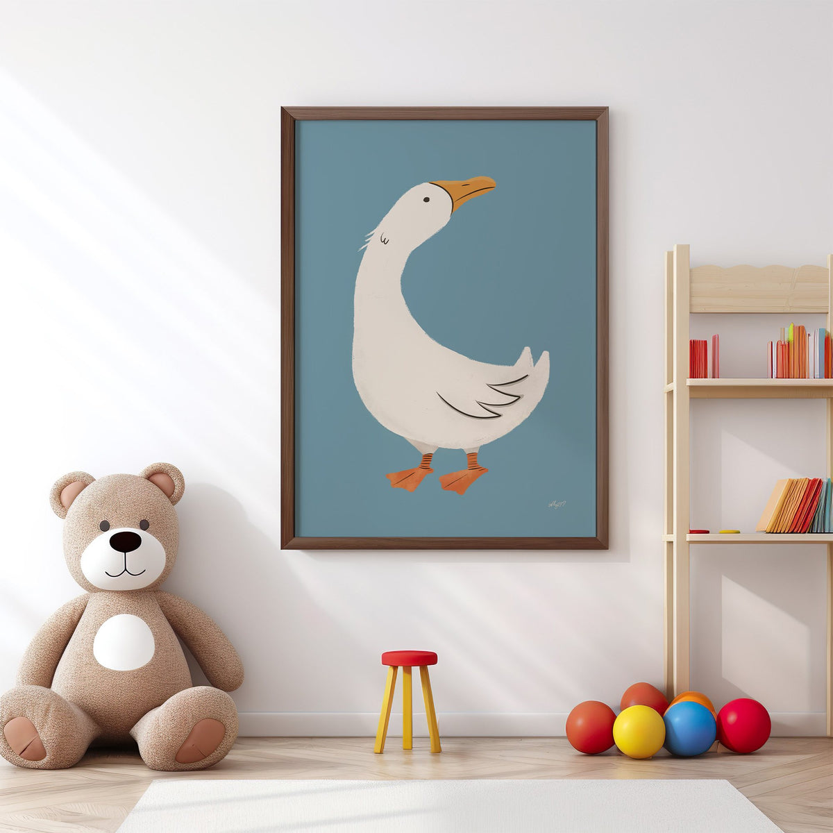 White goose on dusty blue nursery print in a walnut frame above a big teddy bear by a bookshelf