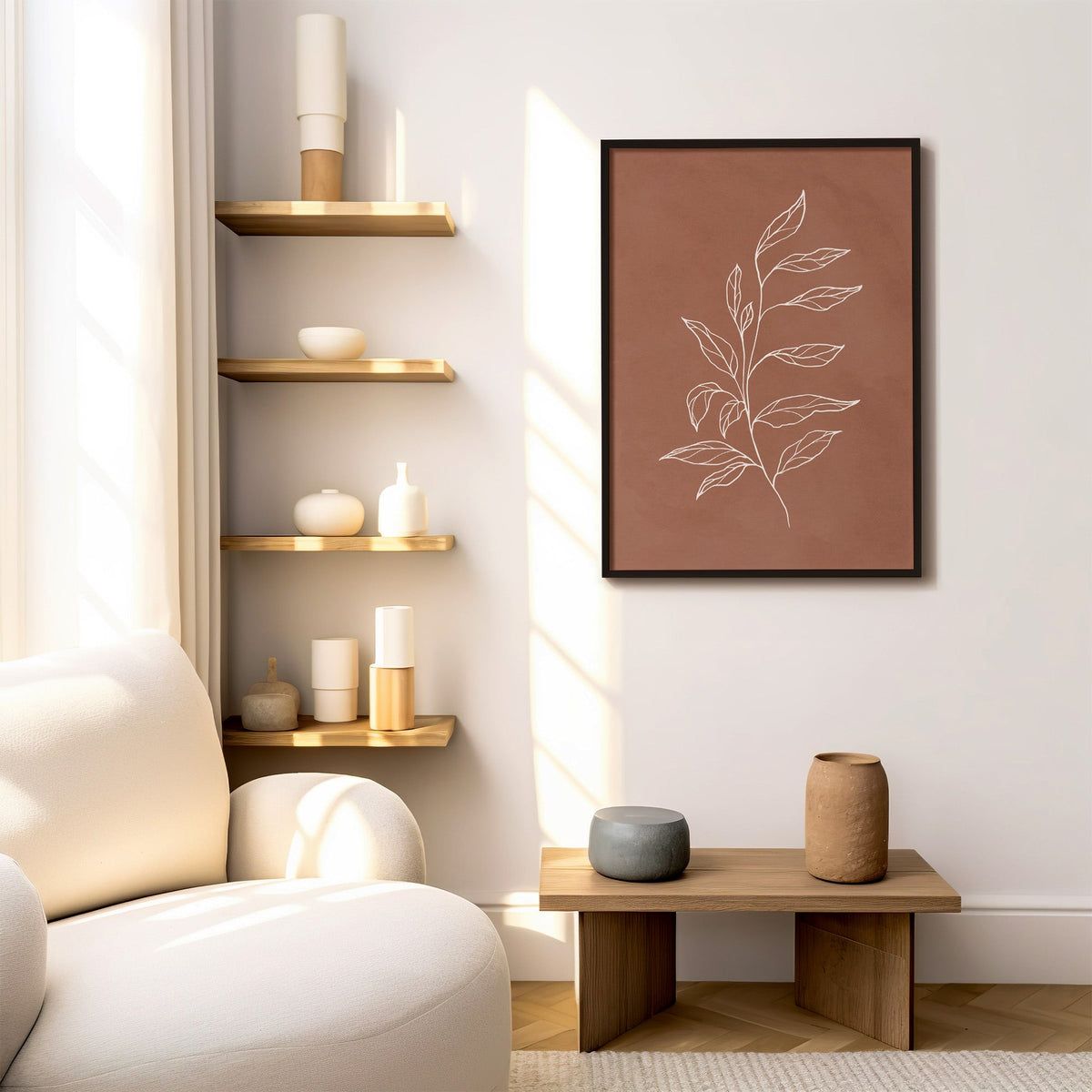 White line leafy sprig on terracotta print in a black frame above a low wood bench beside floating oak shelves
