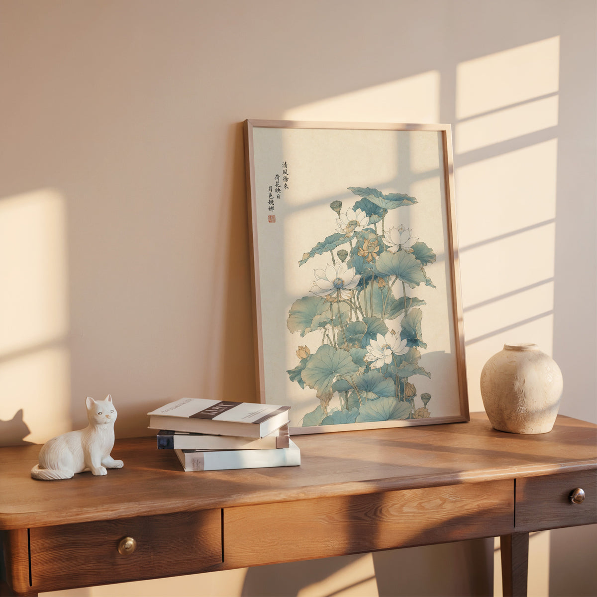 white lotus pond with verse print shown in a rose gold frame leaning on a wooden writing desk with books