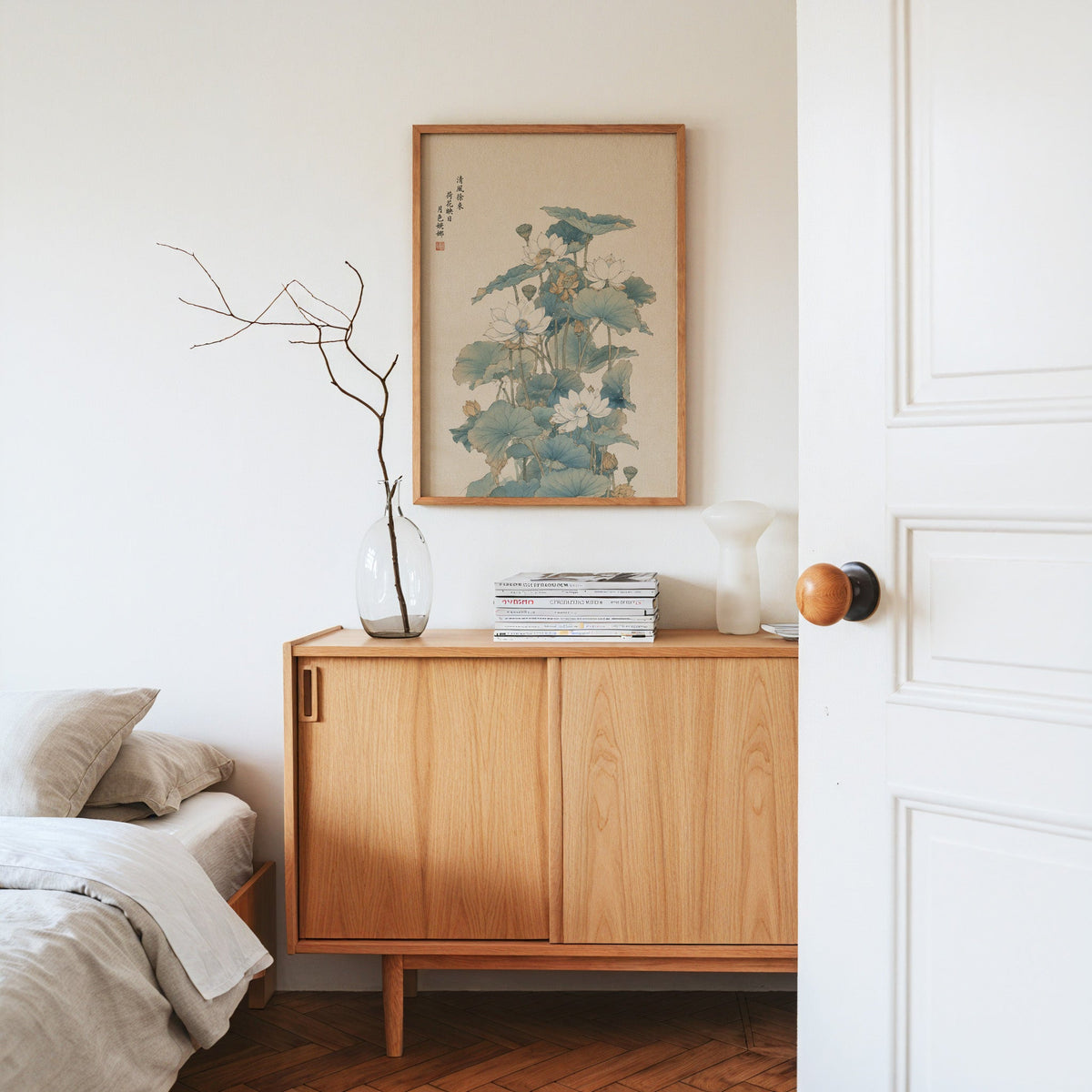 white lotus pond with verse print in an oak frame above an oak sideboard in a bedroom with linen bedding