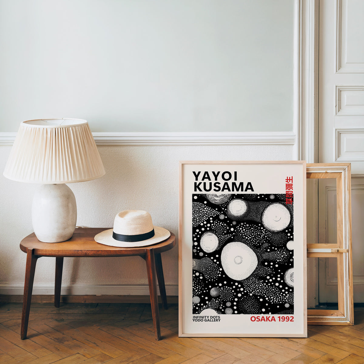 Yayoi Kusama inspired white orbs on black print beside a bench and straw hat