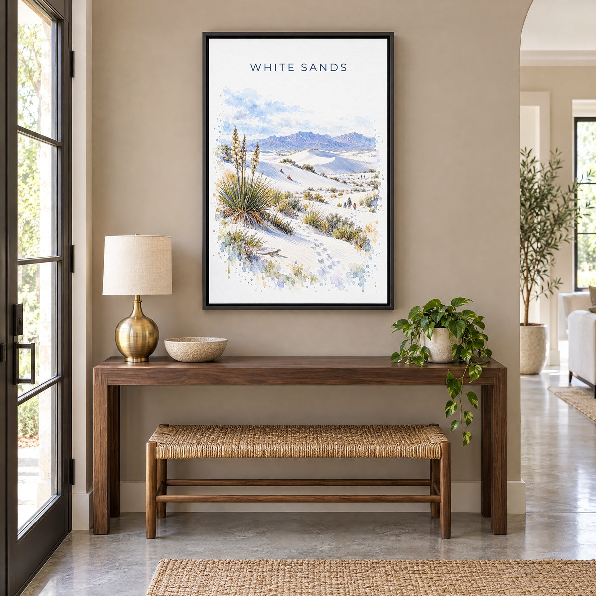 White Sands National Park watercolor print as a black floater canvas above a walnut console and woven bench in an entryway