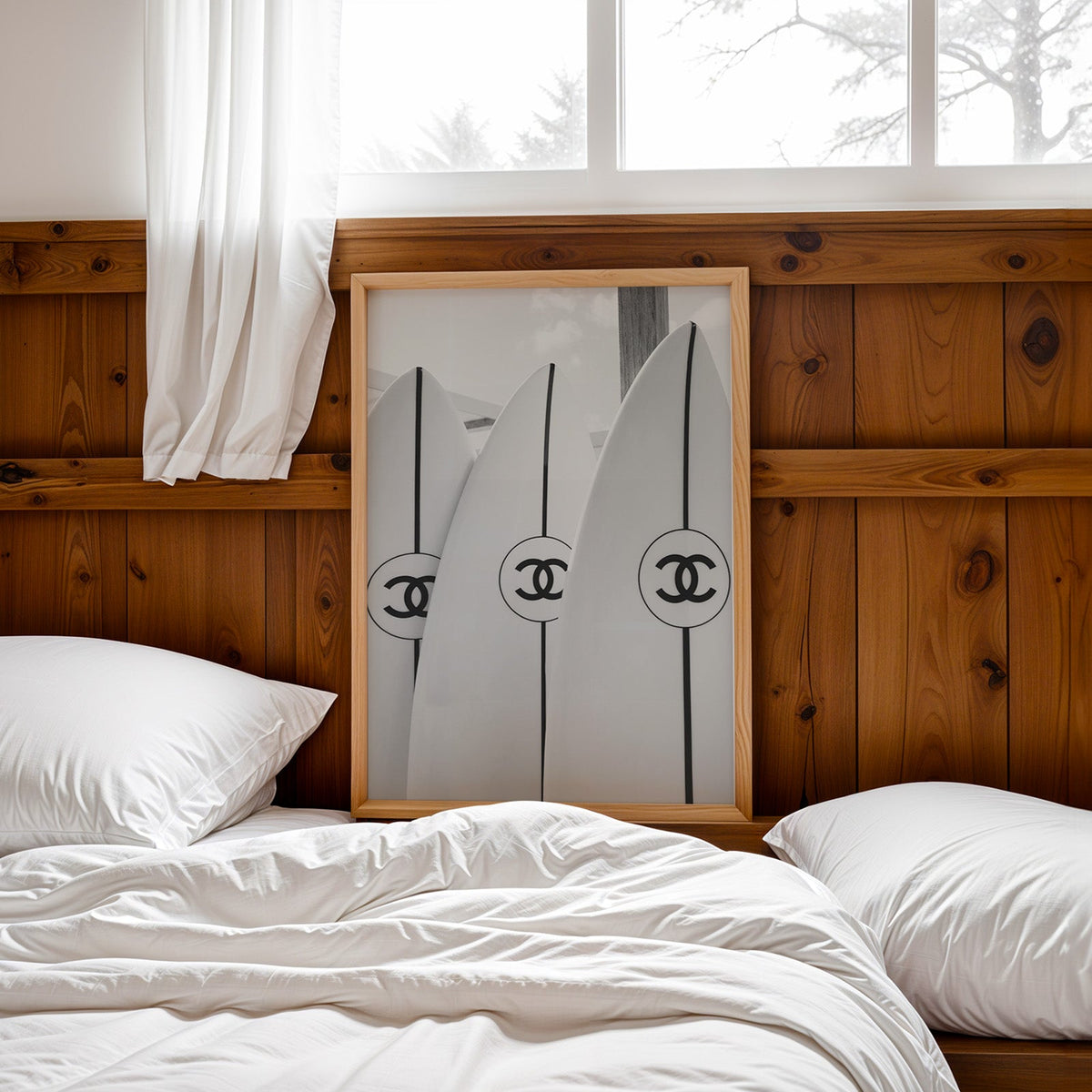 Three white surfboards with black stripes print in a pine frame leaning on a wood headboard over white bedding