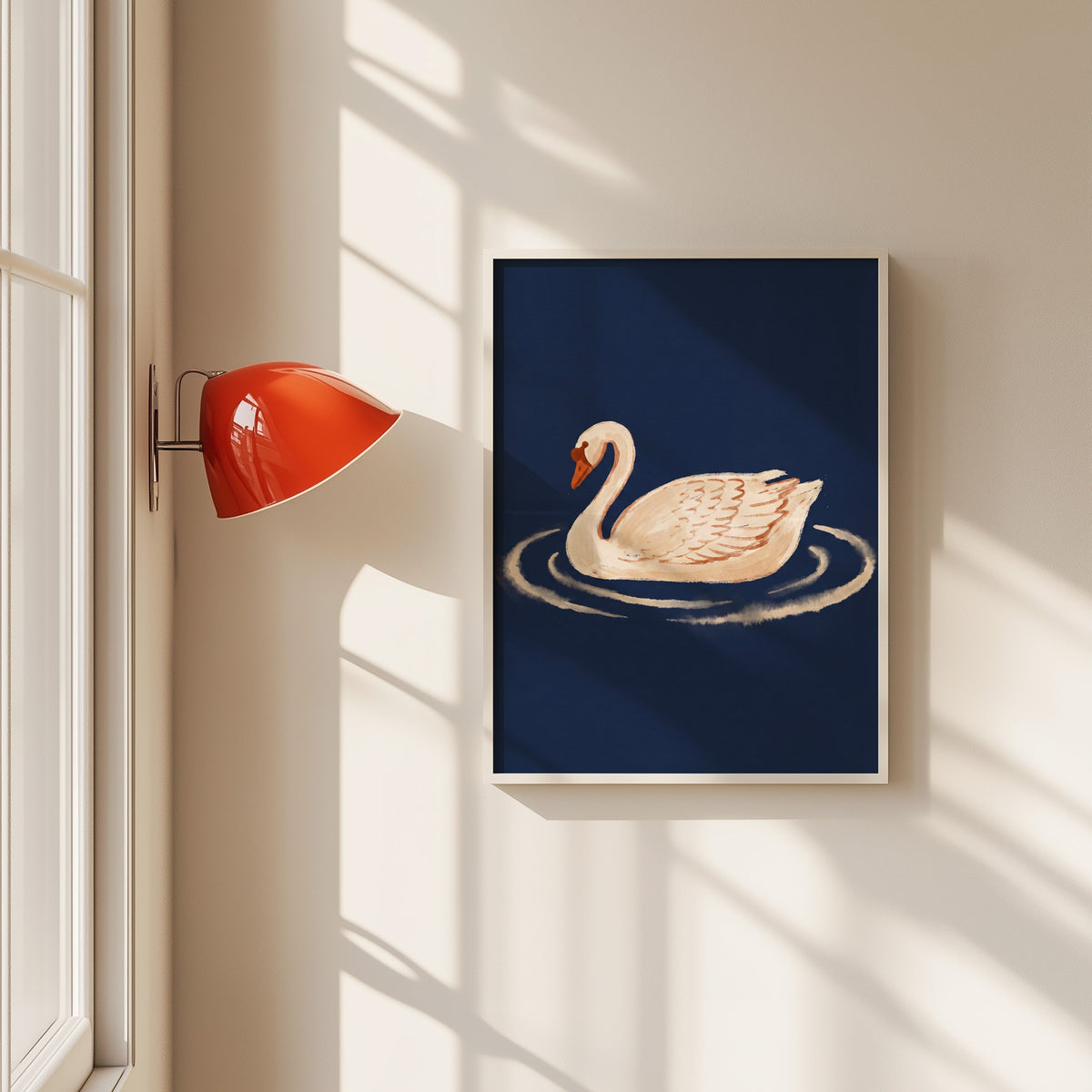 White swan on navy print in a white frame beside a red wall sconce