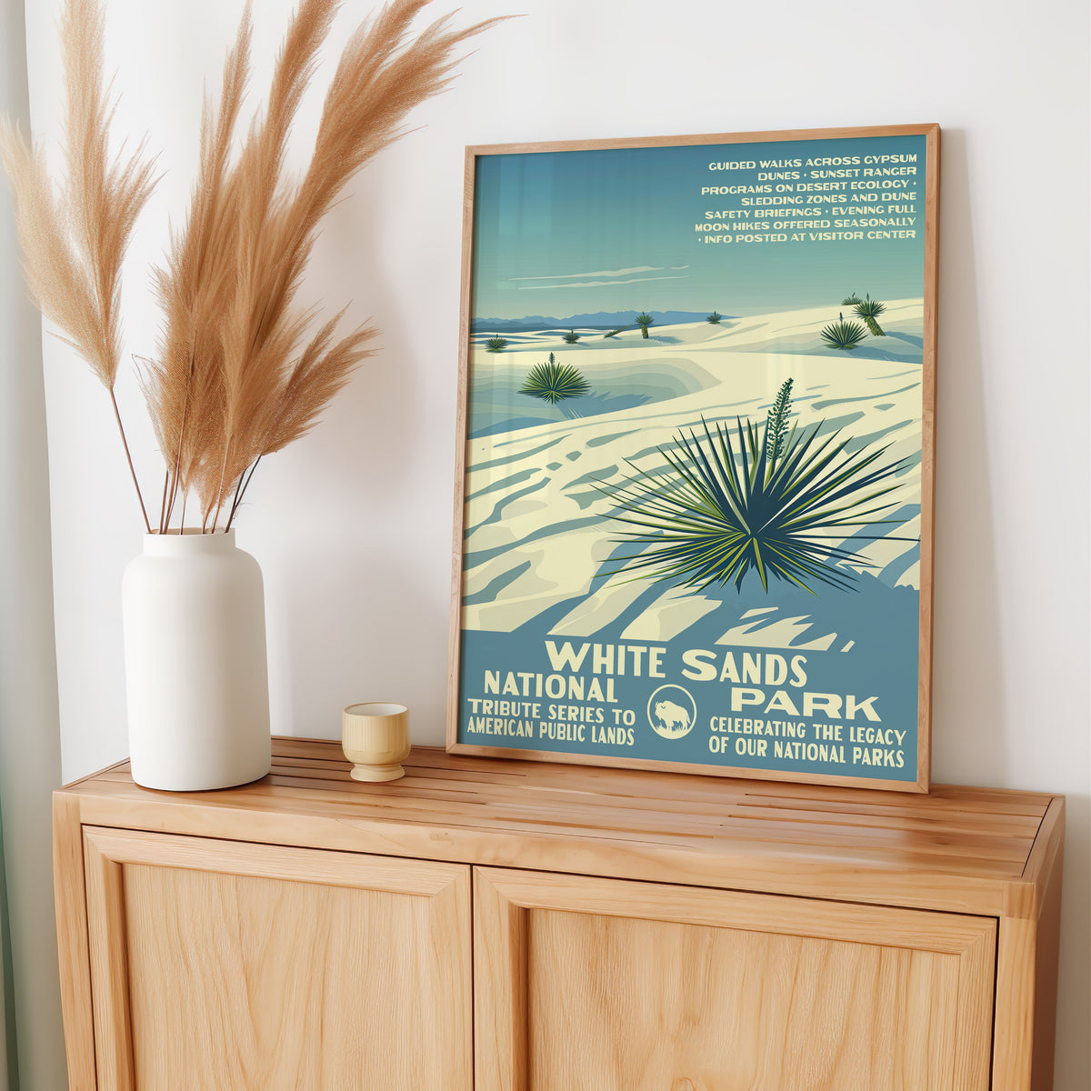 White Sands National Park wall art leaning on an oak sideboard with pampas grass in a vase