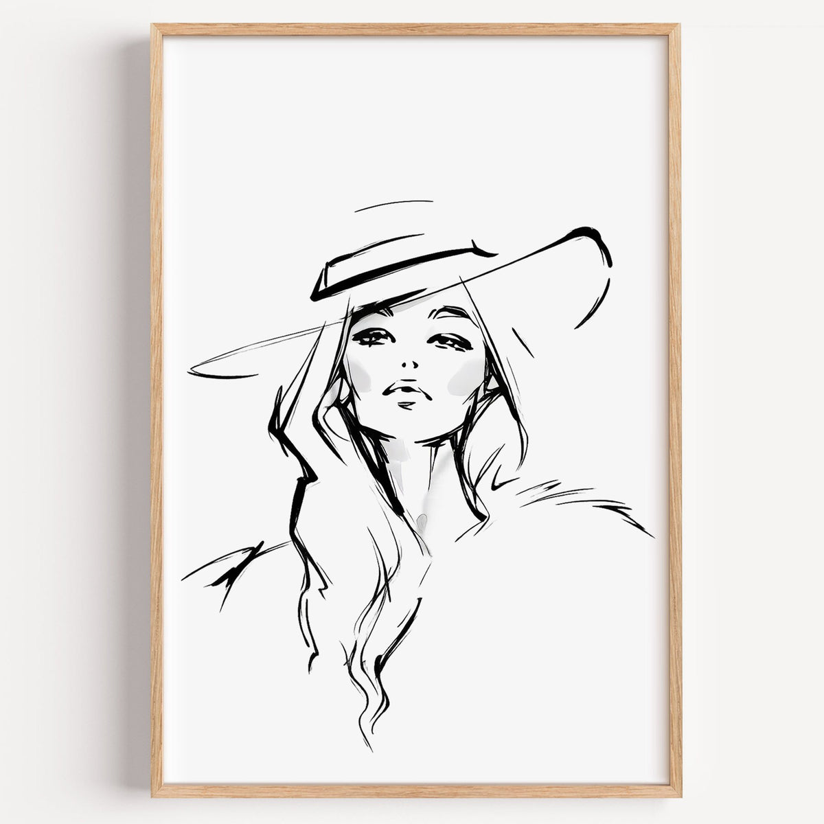 Line sketch of woman in wide brim hat print in a light oak frame on a plain white wall