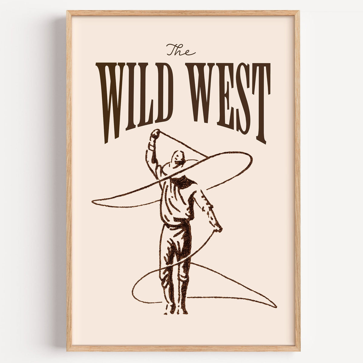 The Wild West lasso print in cream in a light oak frame on a plain white wall