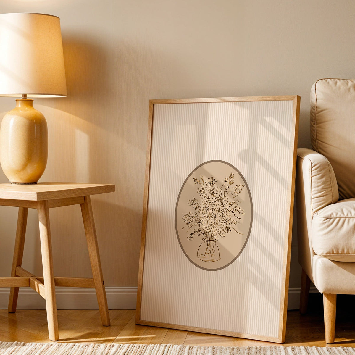 Wildflower bouquet print in an oak frame beside an amber ceramic lamp