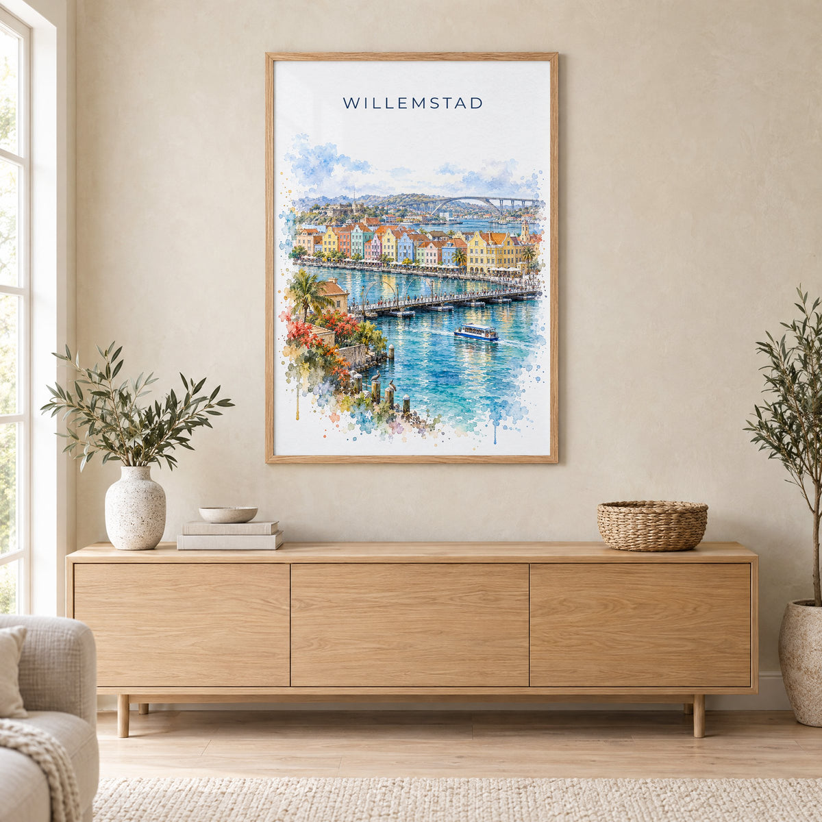 Willemstad watercolor print in an oak frame above a light wood sideboard in a Scandinavian living room