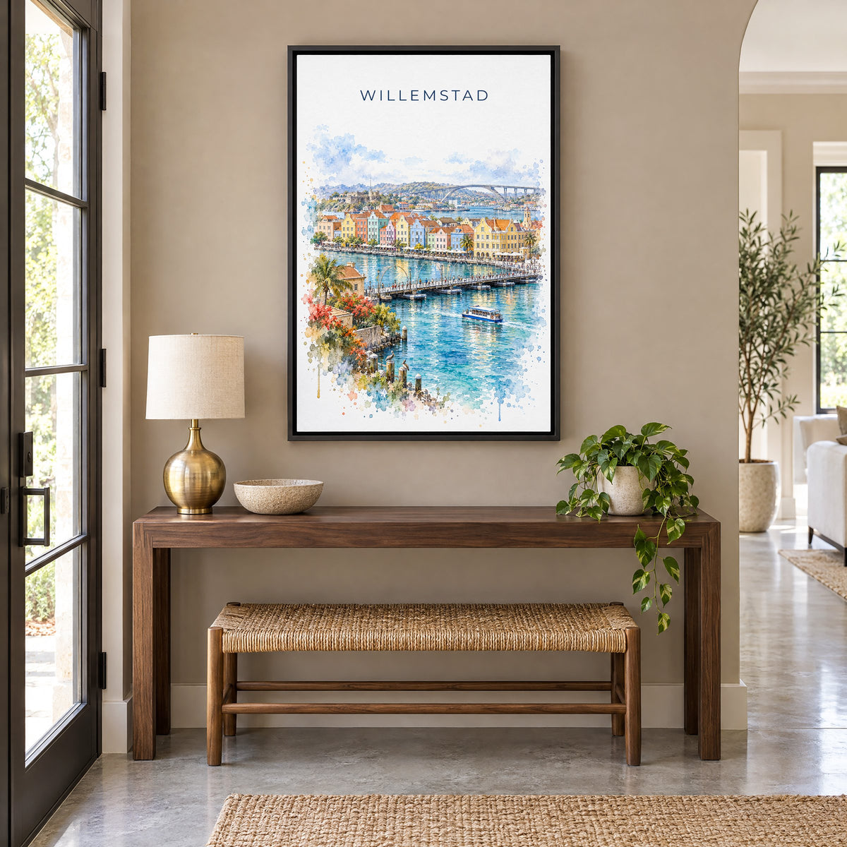 Willemstad watercolor print as a black floater canvas above a walnut console and woven bench in an entryway