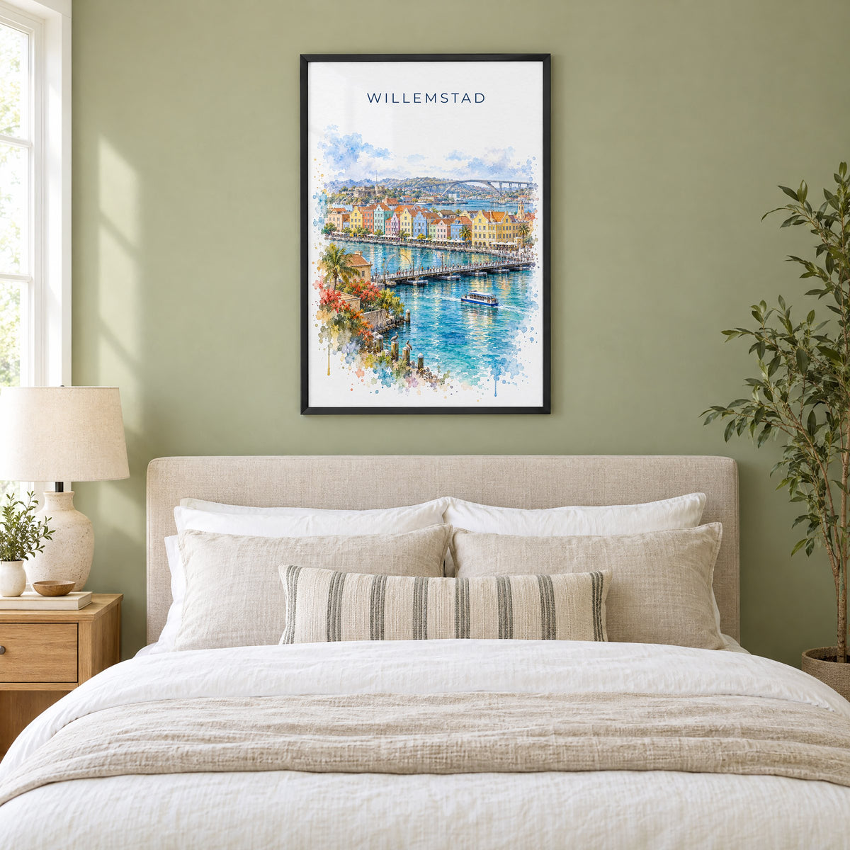 Willemstad watercolor print in a black frame above an upholstered headboard in a sage green bedroom