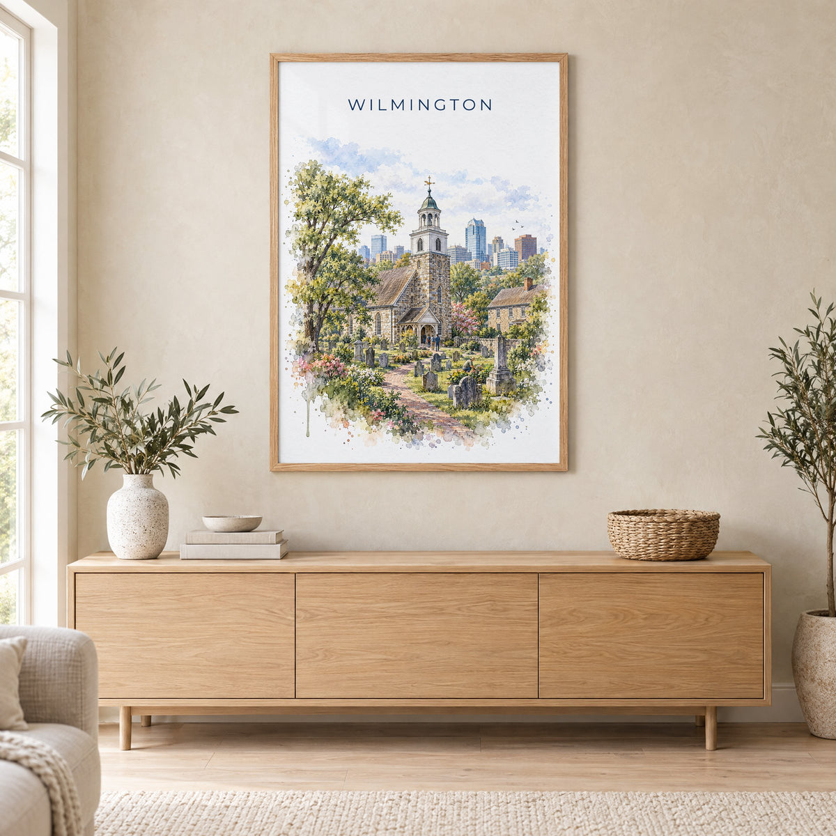 Wilmington, Delaware watercolor print in an oak frame above a light wood sideboard in a Scandinavian living room
