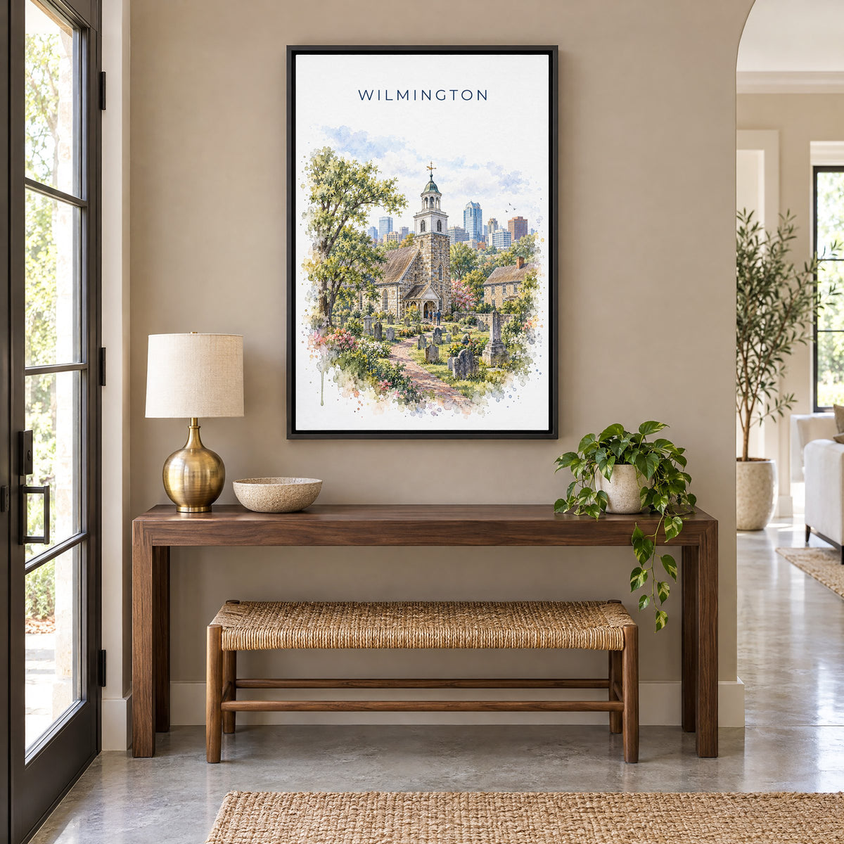 Wilmington, Delaware watercolor print as a black floater canvas above a walnut console and woven bench in an entryway