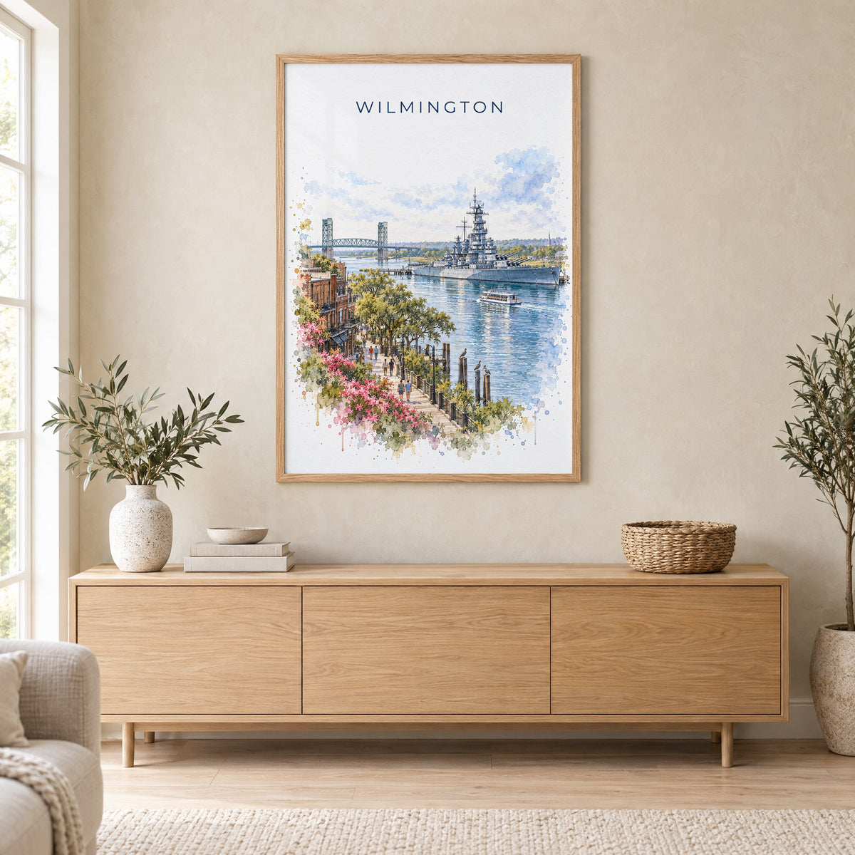 Wilmington, North Carolina watercolor print in an oak frame above a light wood sideboard in a Scandinavian living room