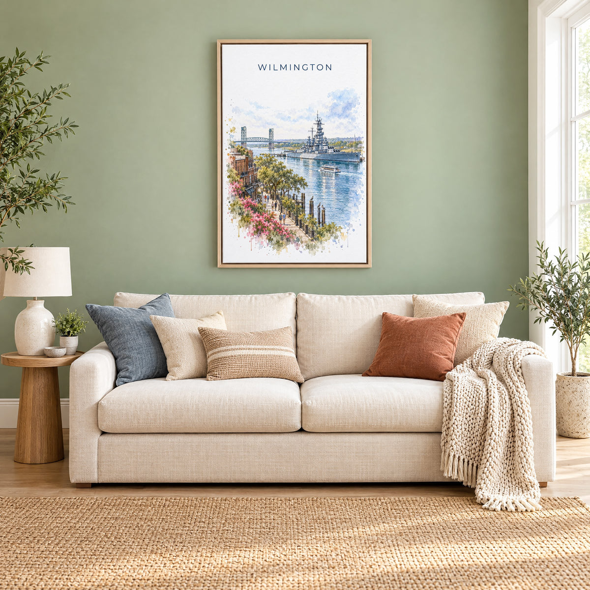Wilmington, North Carolina watercolor print as a natural floater canvas above a cream linen sofa on a sage green wall