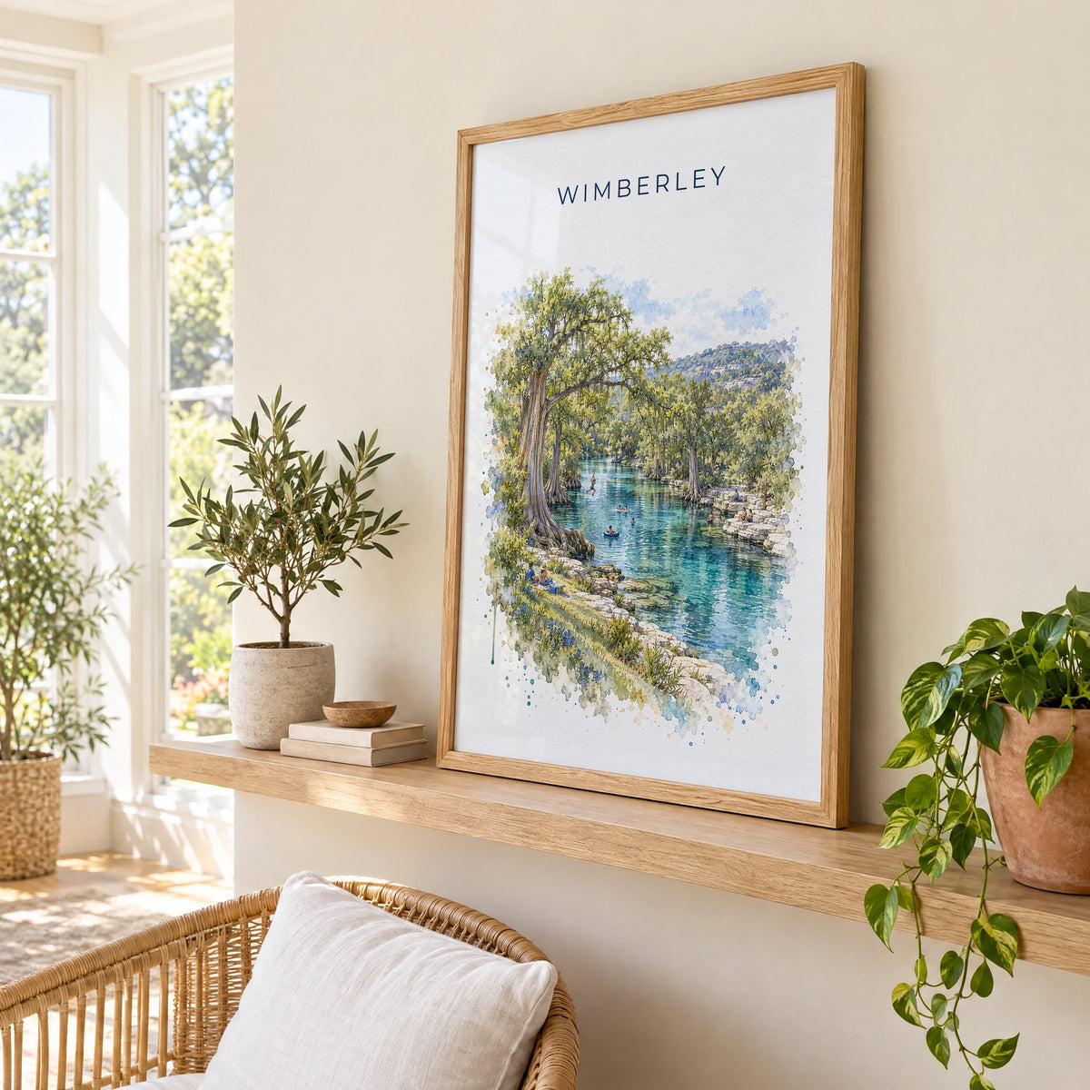 Wimberley, Texas watercolor print in an oak frame on a picture ledge in a sunlit sunroom