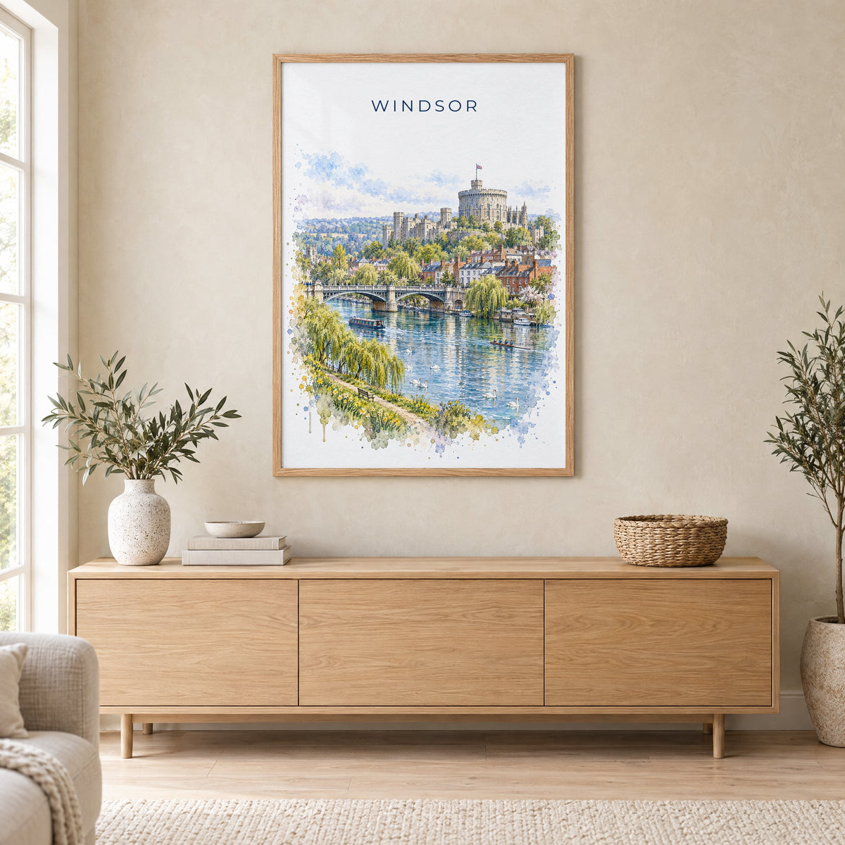 Windsor, England watercolor print in an oak frame above a light wood sideboard in a Scandinavian living room