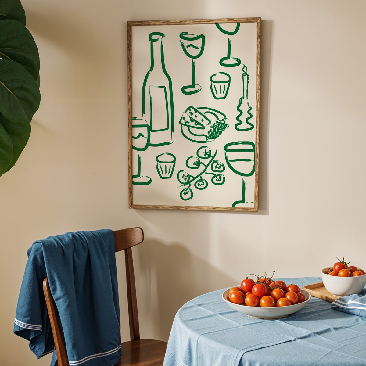 Wine and cheese green pattern print in an oak frame above a blue linen table