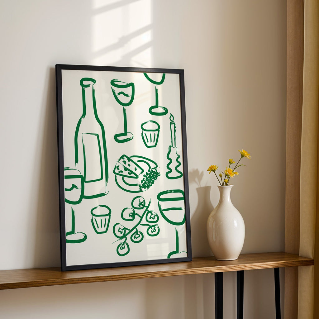 Wine and cheese green pattern print in a black frame on a console table with daisies