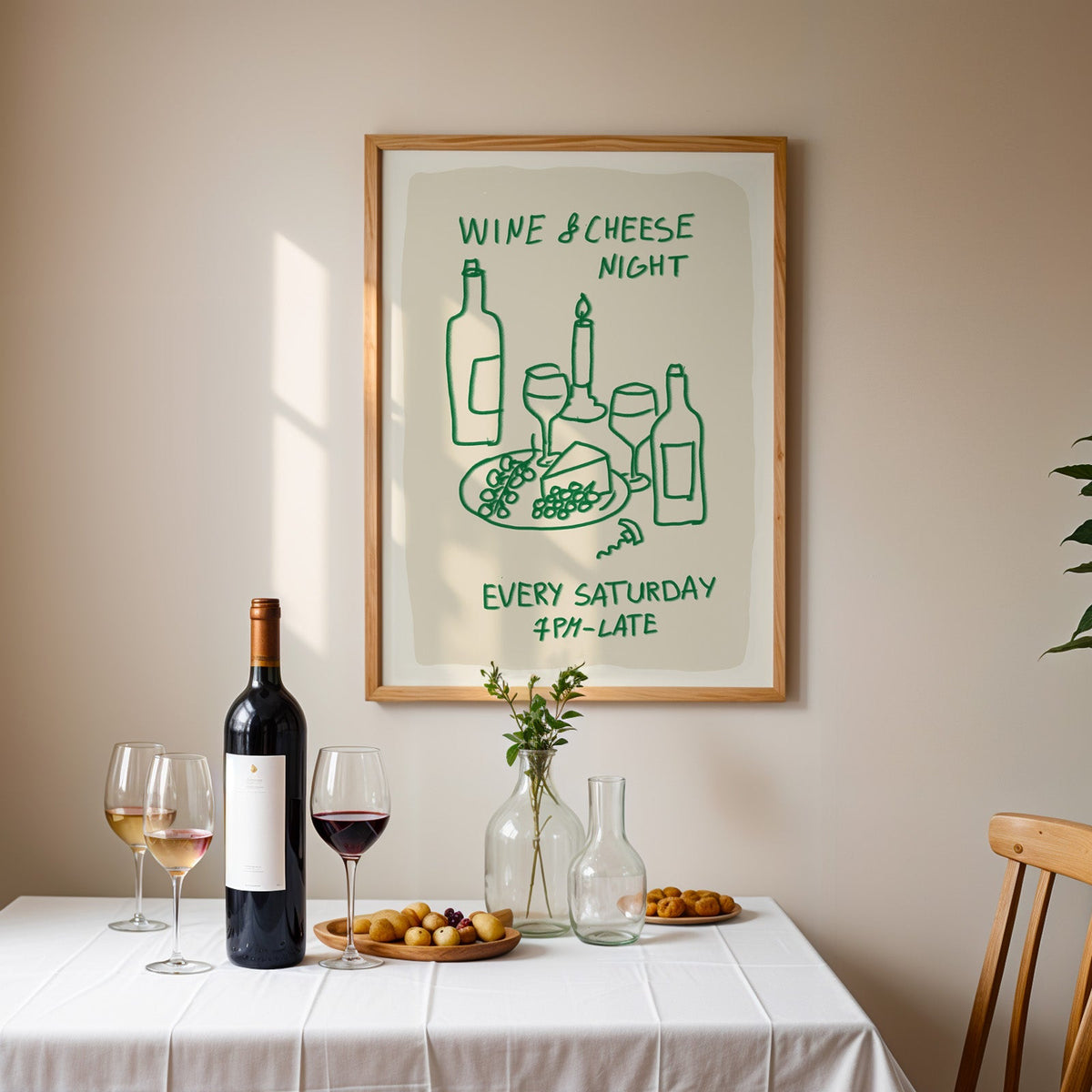 Wine and cheese night print in an oak frame above a table laid with red wine