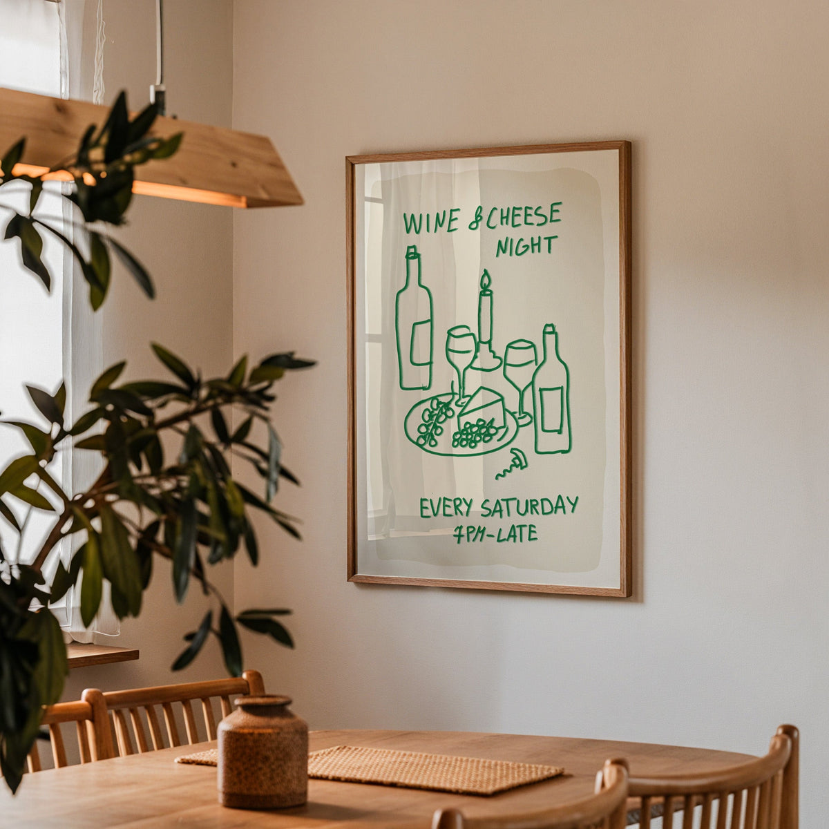 Wine and cheese night print in a walnut frame above a table beside an olive tree
