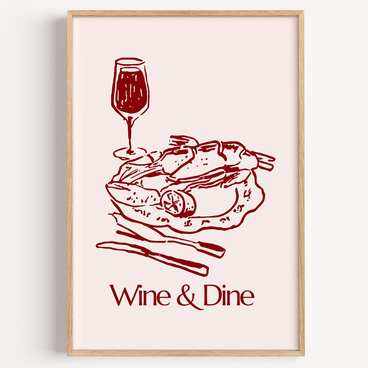 Wine & Dine roast plate burgundy sketch print in a light oak frame on a plain white wall