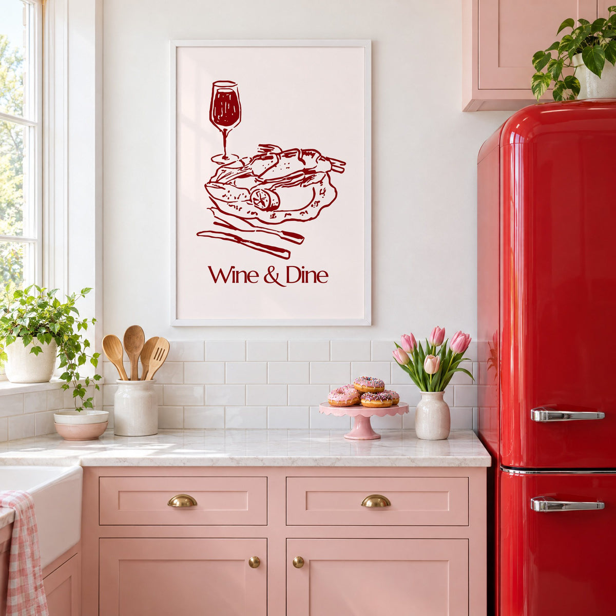 Wine & Dine roast plate burgundy sketch print in a white frame above pink cabinets beside a red retro fridge