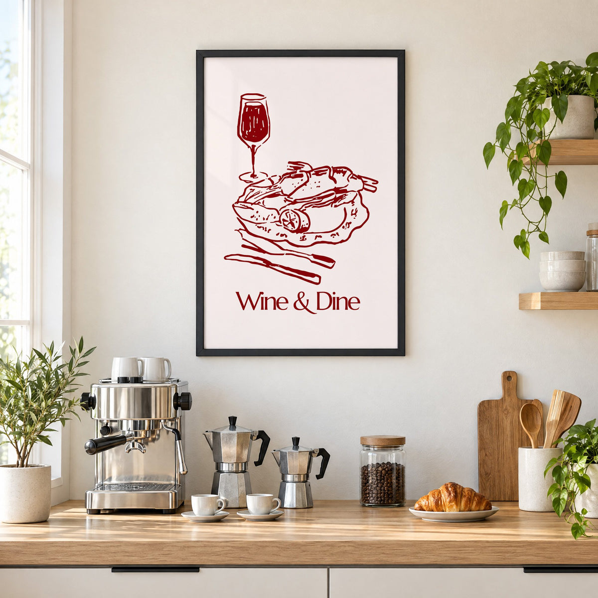 Wine & Dine roast plate burgundy sketch print in a black frame above a home espresso bar with moka pots and espresso cups