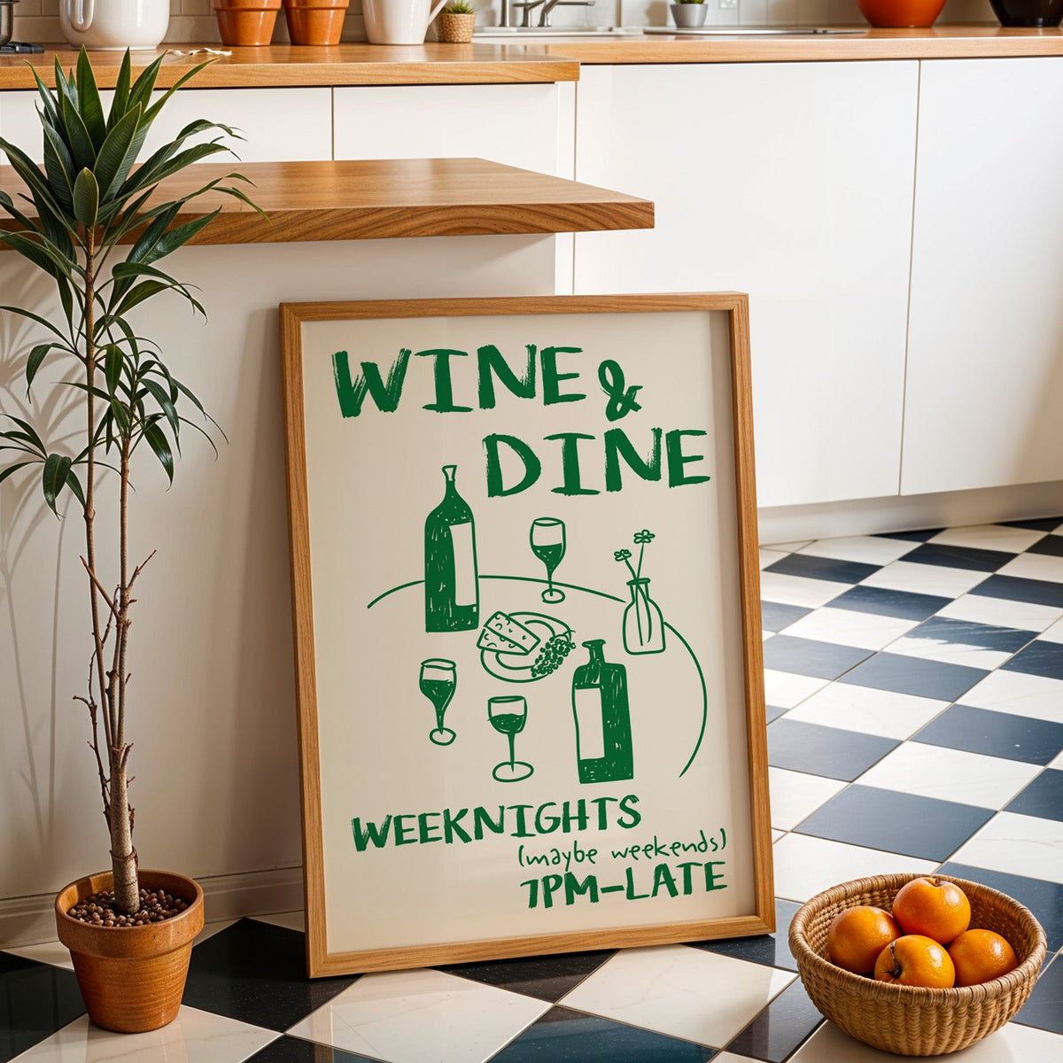 Wine and dine table print in an oak frame by a kitchen island and checkered floor