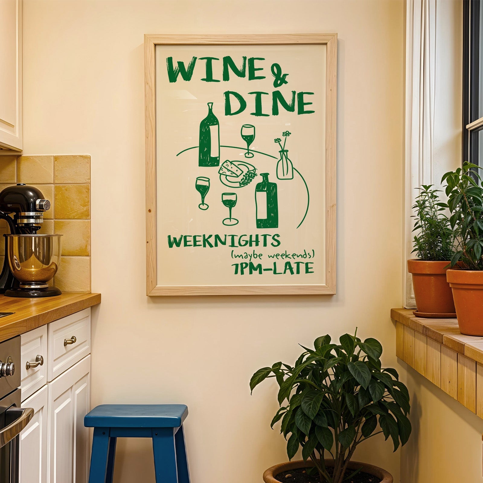 Wine and dine table print in a wood frame on a yellow tiled kitchen wall