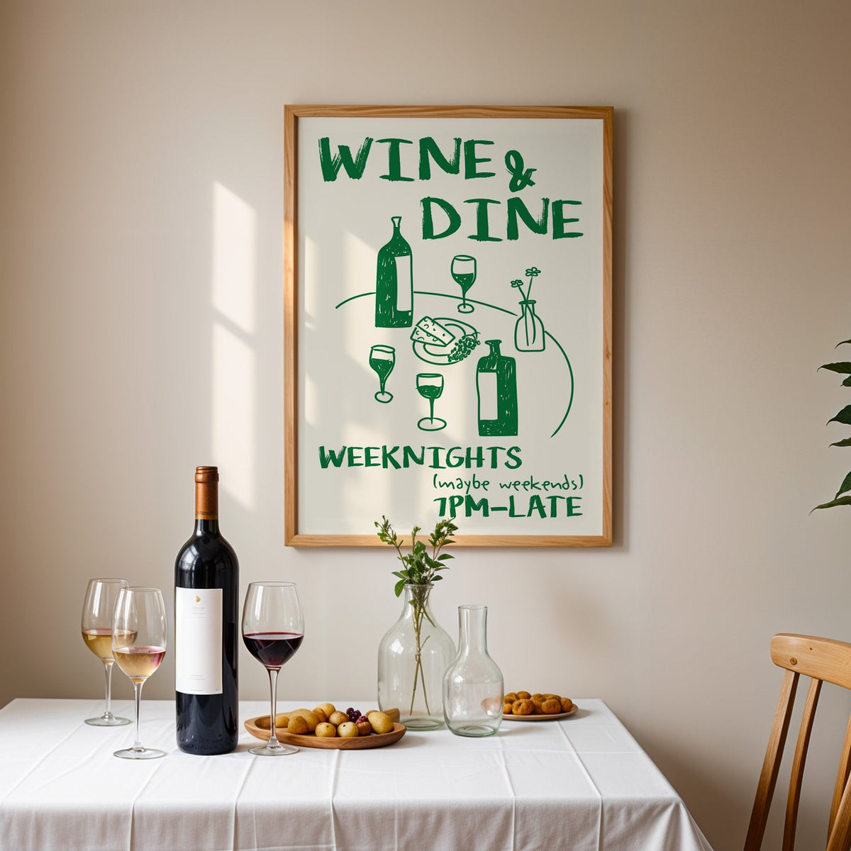 Wine and dine table print in an oak frame above a table laid with red wine