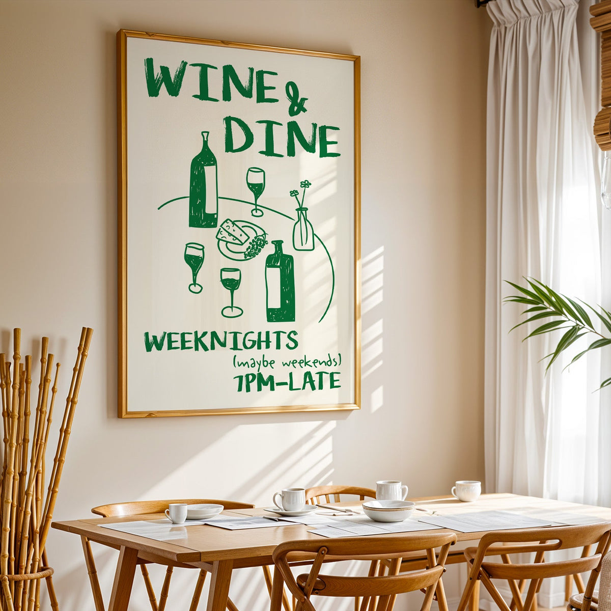 Wine and dine table print in a gold frame above a sunlit breakfast table