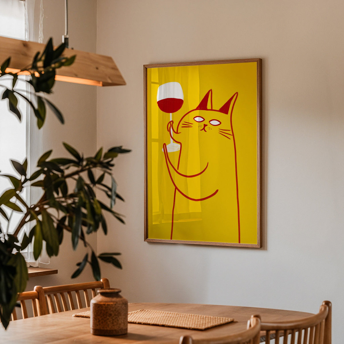 Wine Cat print in a walnut frame above a dining table with olive branches