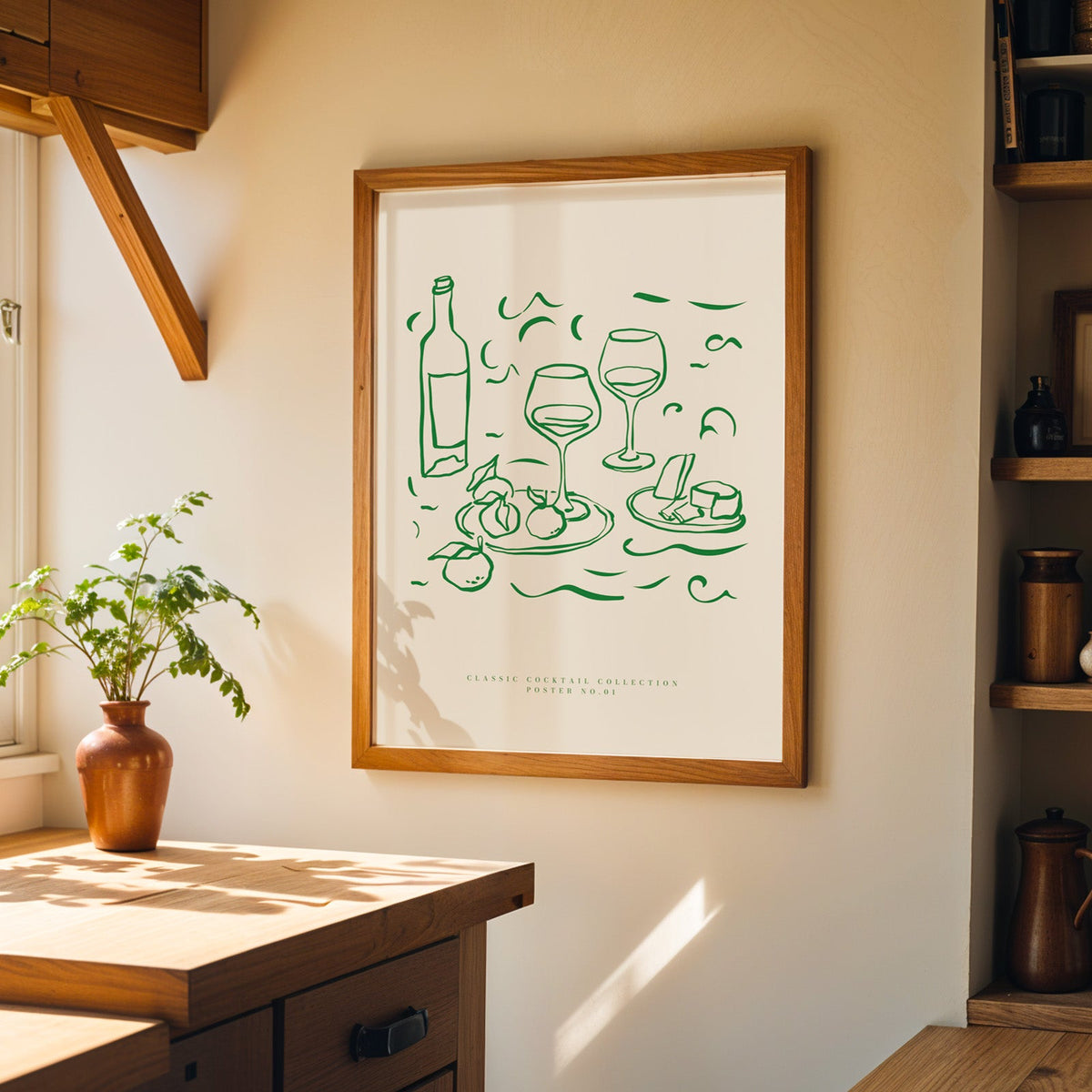 Green line wine and cheese print in a walnut frame on a cream kitchen wall above the island